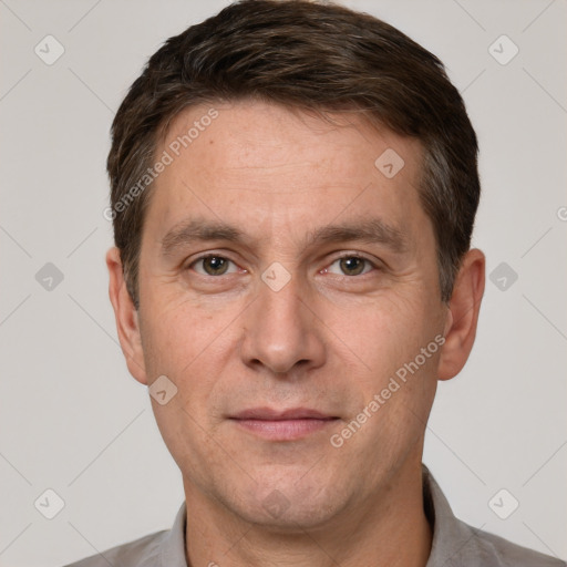 Joyful white adult male with short  brown hair and grey eyes