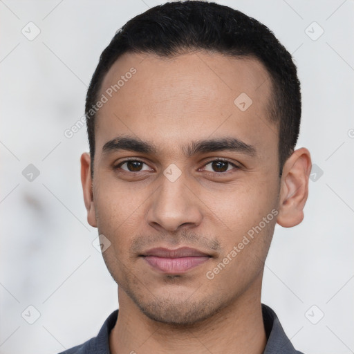 Joyful latino young-adult male with short  black hair and brown eyes