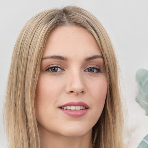 Joyful white young-adult female with long  brown hair and green eyes