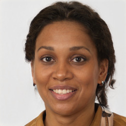 Joyful black adult female with medium  brown hair and brown eyes