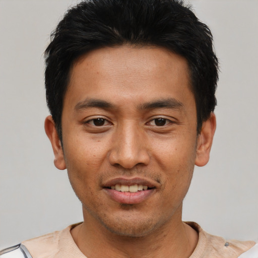 Joyful asian young-adult male with short  black hair and brown eyes