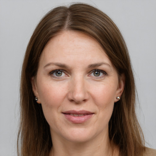 Joyful white young-adult female with long  brown hair and grey eyes