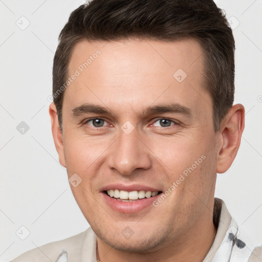 Joyful white young-adult male with short  brown hair and brown eyes