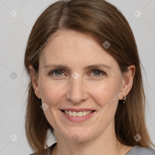 Joyful white adult female with medium  brown hair and grey eyes