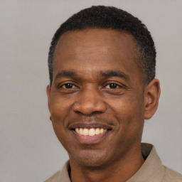 Joyful latino adult male with short  black hair and brown eyes