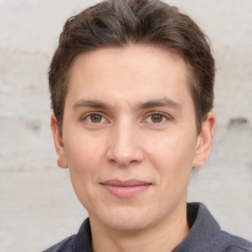 Joyful white adult male with short  brown hair and grey eyes