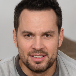 Joyful white adult male with short  brown hair and brown eyes