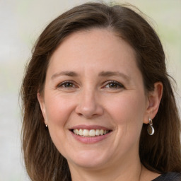 Joyful white adult female with medium  brown hair and grey eyes