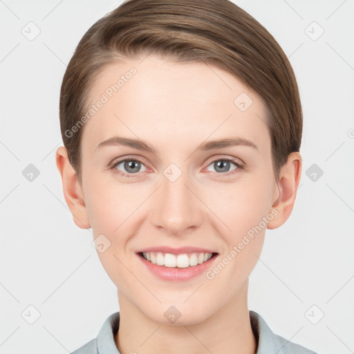 Joyful white young-adult female with short  brown hair and grey eyes