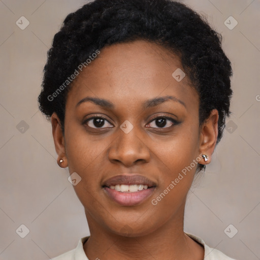 Joyful black young-adult female with short  black hair and brown eyes