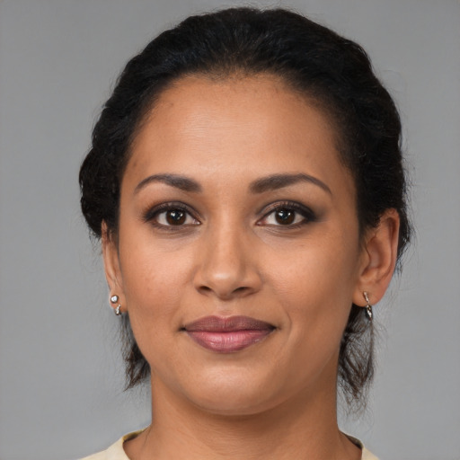 Joyful latino young-adult female with medium  brown hair and brown eyes