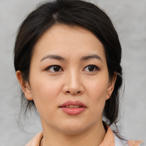 Joyful asian young-adult female with medium  brown hair and brown eyes