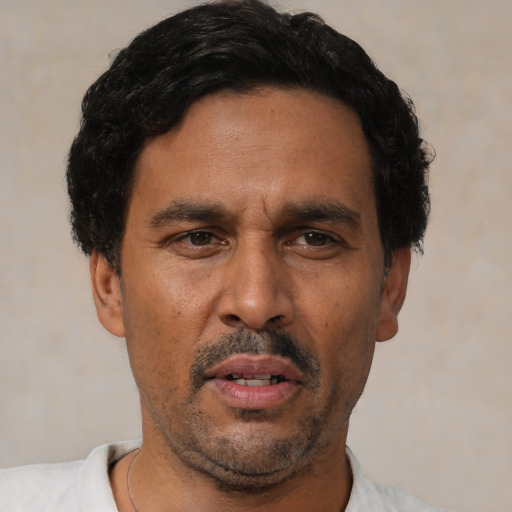 Neutral latino adult male with short  black hair and brown eyes