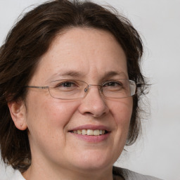 Joyful white adult female with medium  brown hair and grey eyes