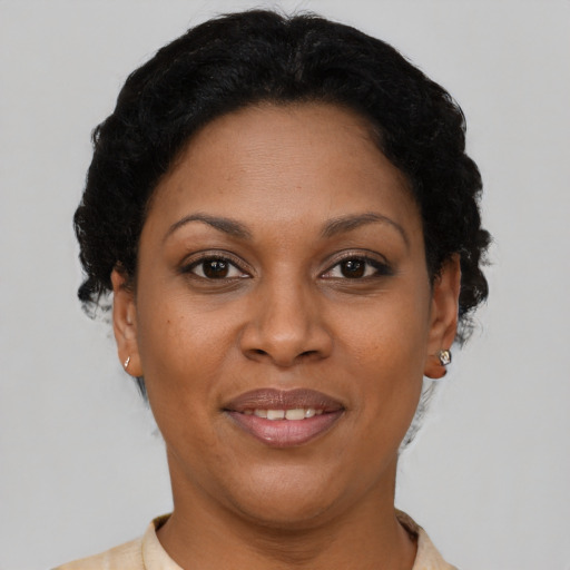 Joyful latino adult female with short  brown hair and brown eyes