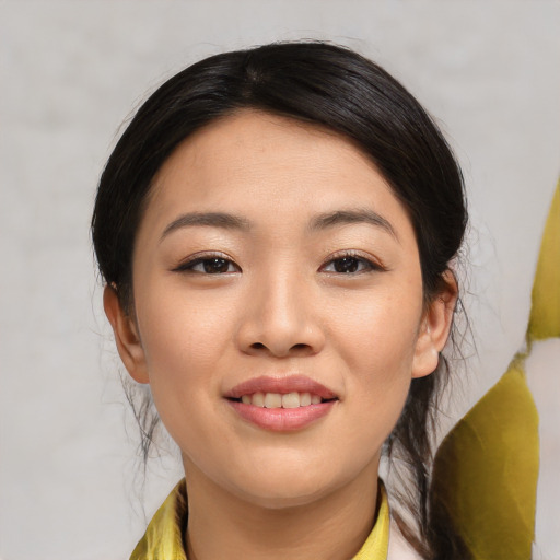 Joyful asian young-adult female with medium  black hair and brown eyes