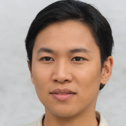 Joyful asian young-adult male with short  brown hair and brown eyes