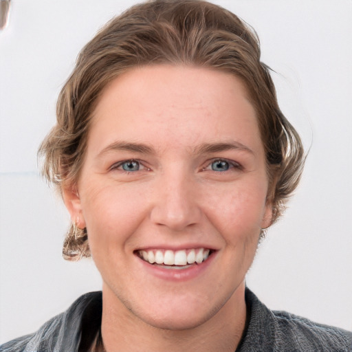 Joyful white young-adult female with medium  brown hair and blue eyes