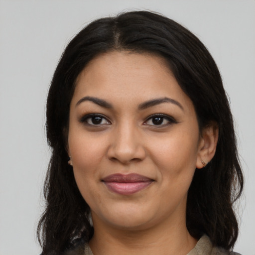 Joyful latino young-adult female with long  black hair and brown eyes