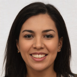 Joyful latino young-adult female with long  brown hair and brown eyes