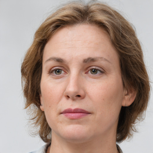 Joyful white adult female with medium  brown hair and grey eyes