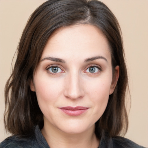 Joyful white young-adult female with medium  brown hair and blue eyes