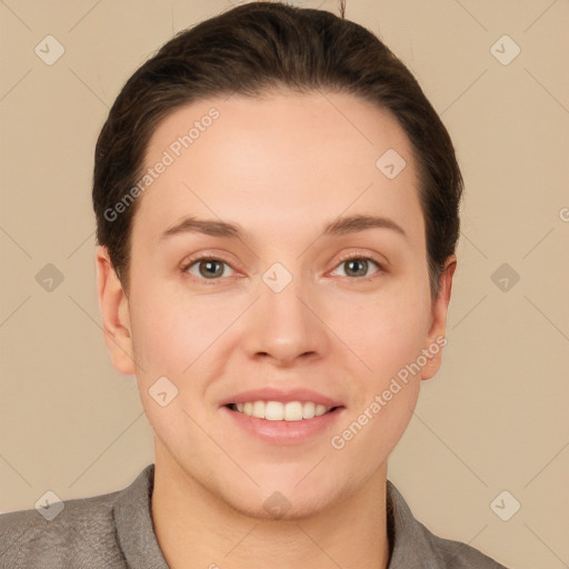 Joyful white young-adult female with short  brown hair and grey eyes