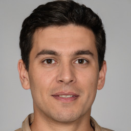 Joyful white young-adult male with short  brown hair and brown eyes