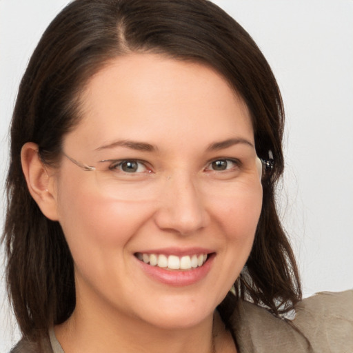 Joyful white young-adult female with medium  brown hair and grey eyes