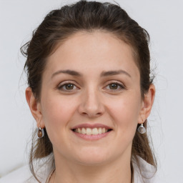 Joyful white young-adult female with medium  brown hair and grey eyes