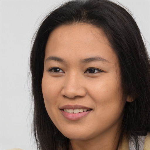 Joyful asian young-adult female with long  brown hair and brown eyes