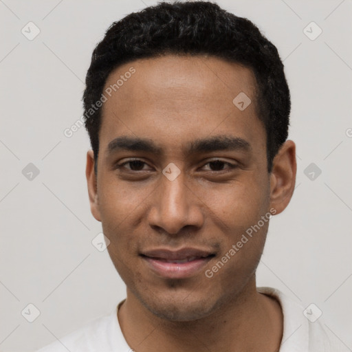 Joyful black young-adult male with short  black hair and brown eyes