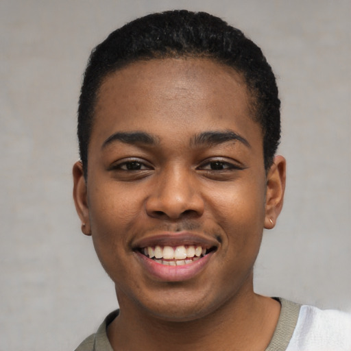 Joyful black young-adult male with short  black hair and brown eyes