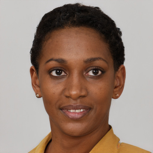 Joyful black young-adult female with short  brown hair and brown eyes
