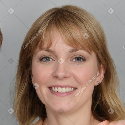 Joyful white adult female with medium  brown hair and blue eyes