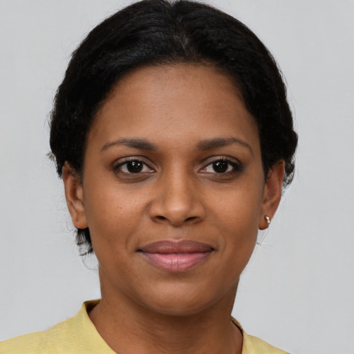 Joyful black young-adult female with short  brown hair and brown eyes