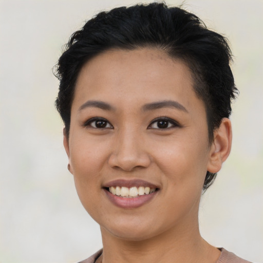 Joyful latino young-adult female with short  black hair and brown eyes
