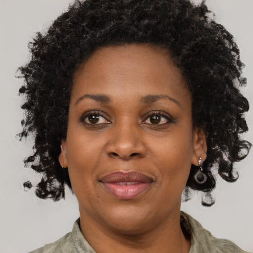 Joyful black adult female with short  brown hair and brown eyes