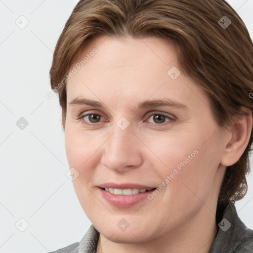 Joyful white young-adult female with medium  brown hair and grey eyes