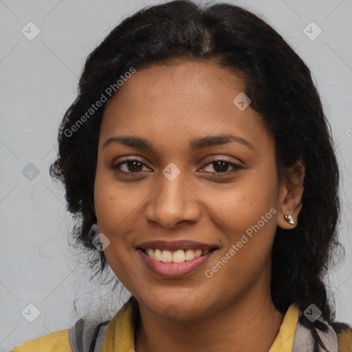 Joyful black young-adult female with long  black hair and brown eyes