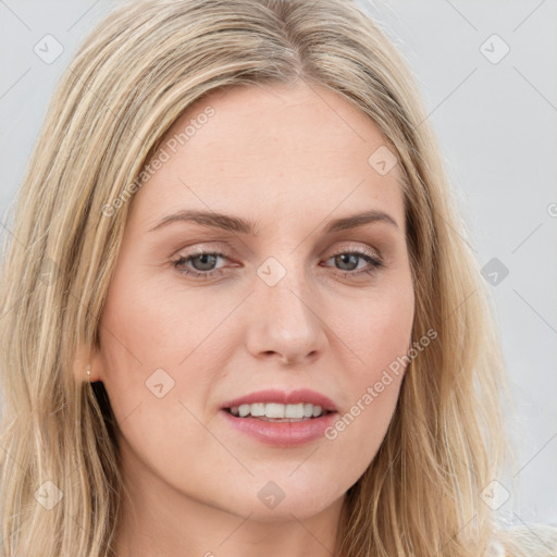 Joyful white young-adult female with long  brown hair and blue eyes