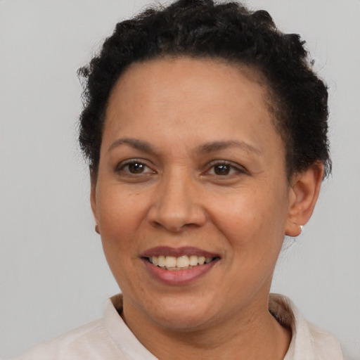 Joyful latino adult female with short  brown hair and brown eyes