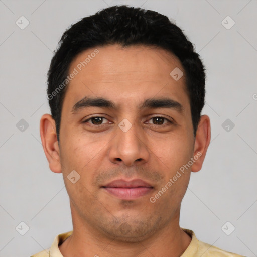 Joyful latino young-adult male with short  black hair and brown eyes