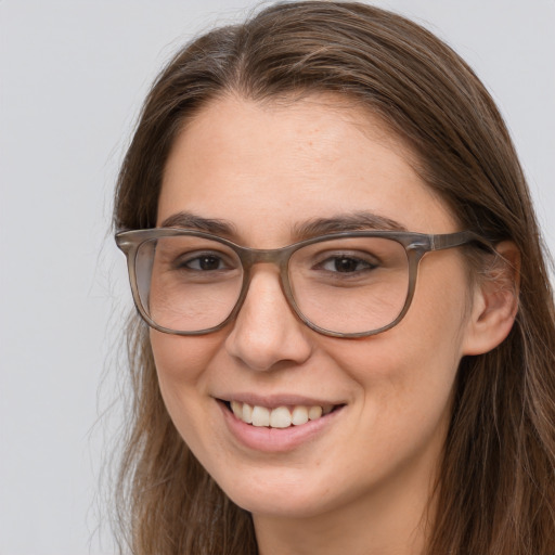 Joyful white adult female with long  brown hair and brown eyes