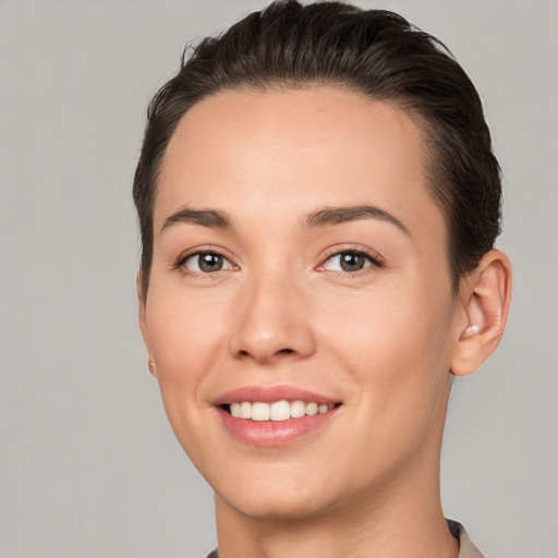 Joyful white young-adult female with short  brown hair and brown eyes