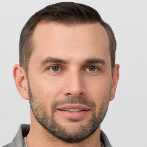 Joyful white young-adult male with short  brown hair and brown eyes