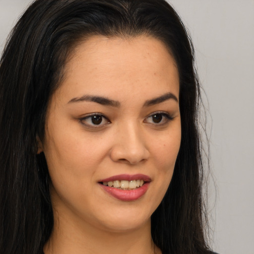 Joyful asian young-adult female with long  brown hair and brown eyes