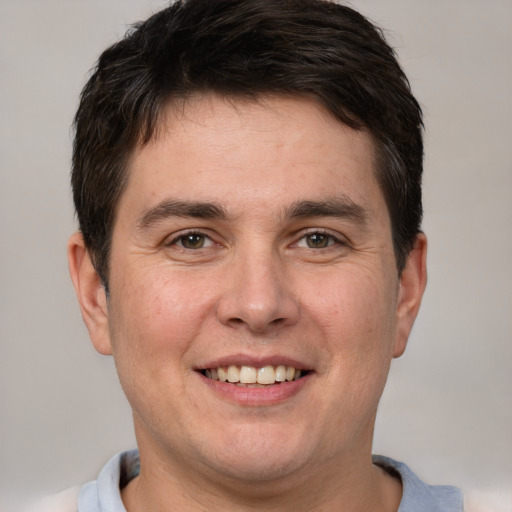 Joyful white adult male with short  brown hair and brown eyes