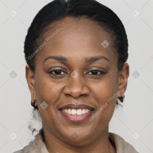 Joyful black adult female with short  brown hair and brown eyes