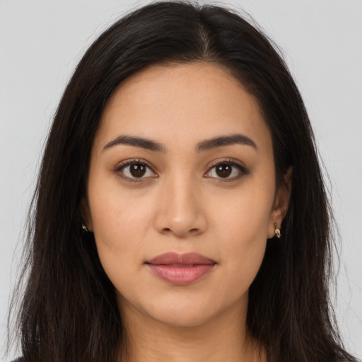 Joyful latino young-adult female with long  brown hair and brown eyes